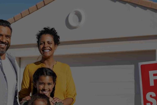 A happy family standing in front of a Scottsdale home for sale.